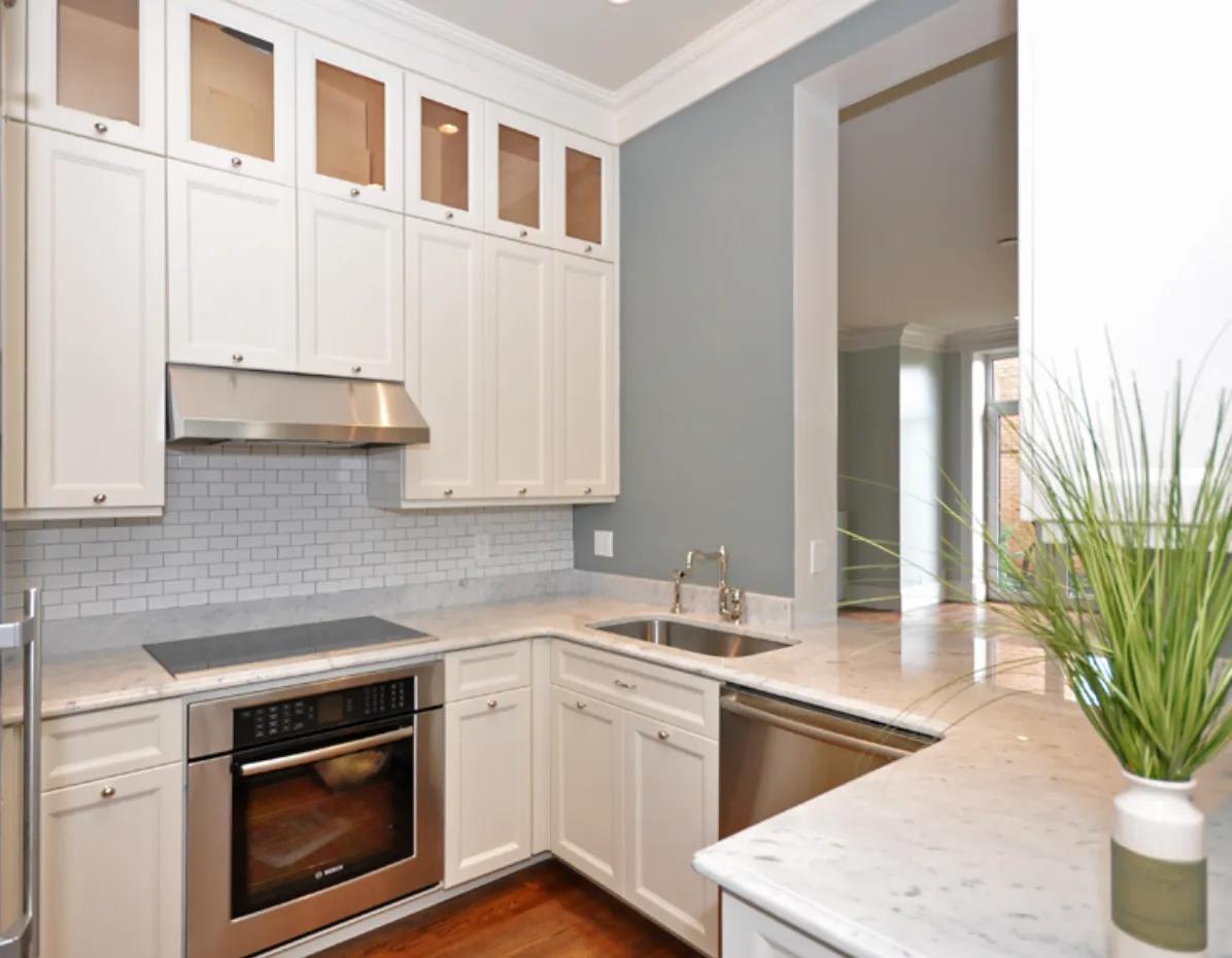 Renovated kitchen with white cabinetry in a Beacon Street condominium