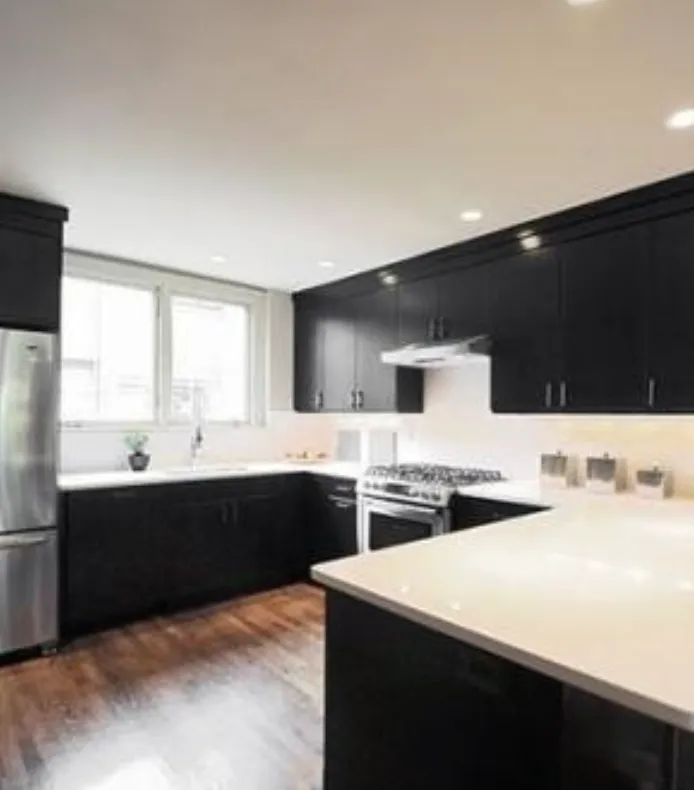 Kitchen with dark cabinetry and white counters in a Chauncy Lane condominium
