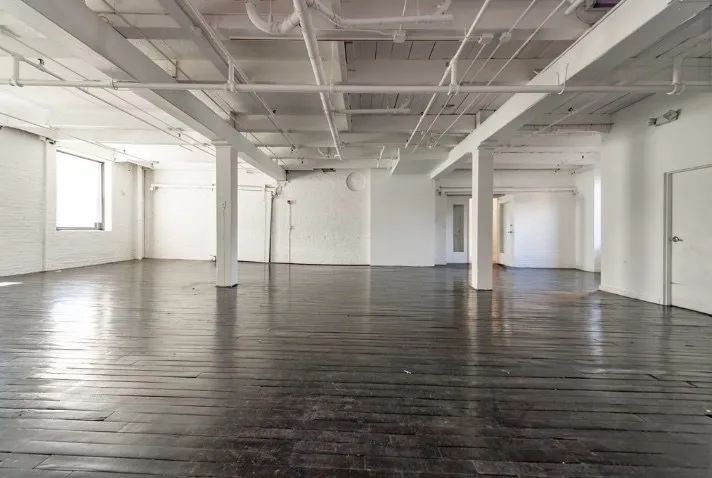 Open loft office space with exposed ceiling and new flooring