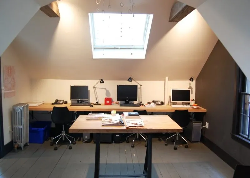 Office fit-out under a skylight with shared work tables