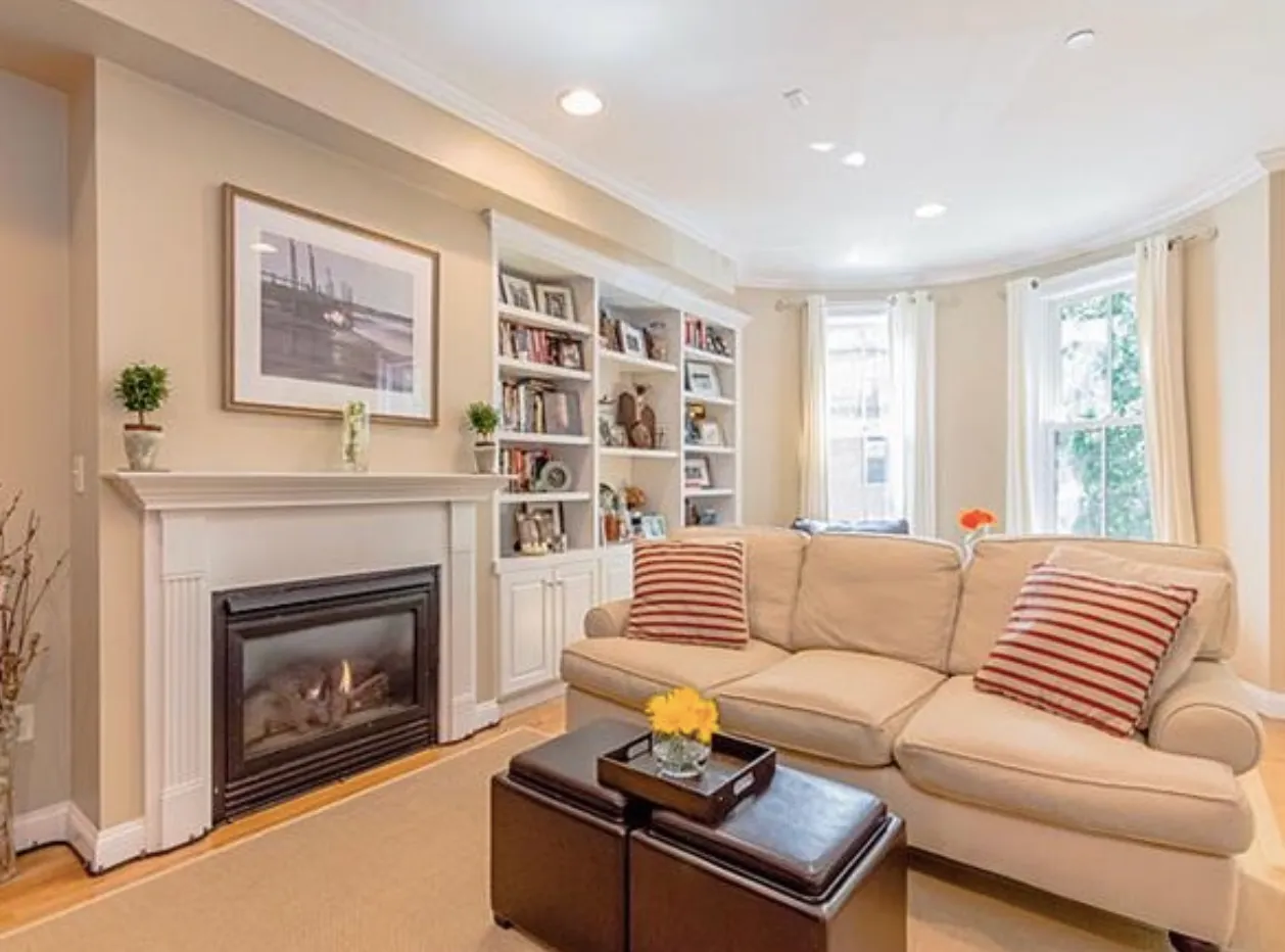 Living room with fireplace and built-in shelving in an East Brookline Street condominium