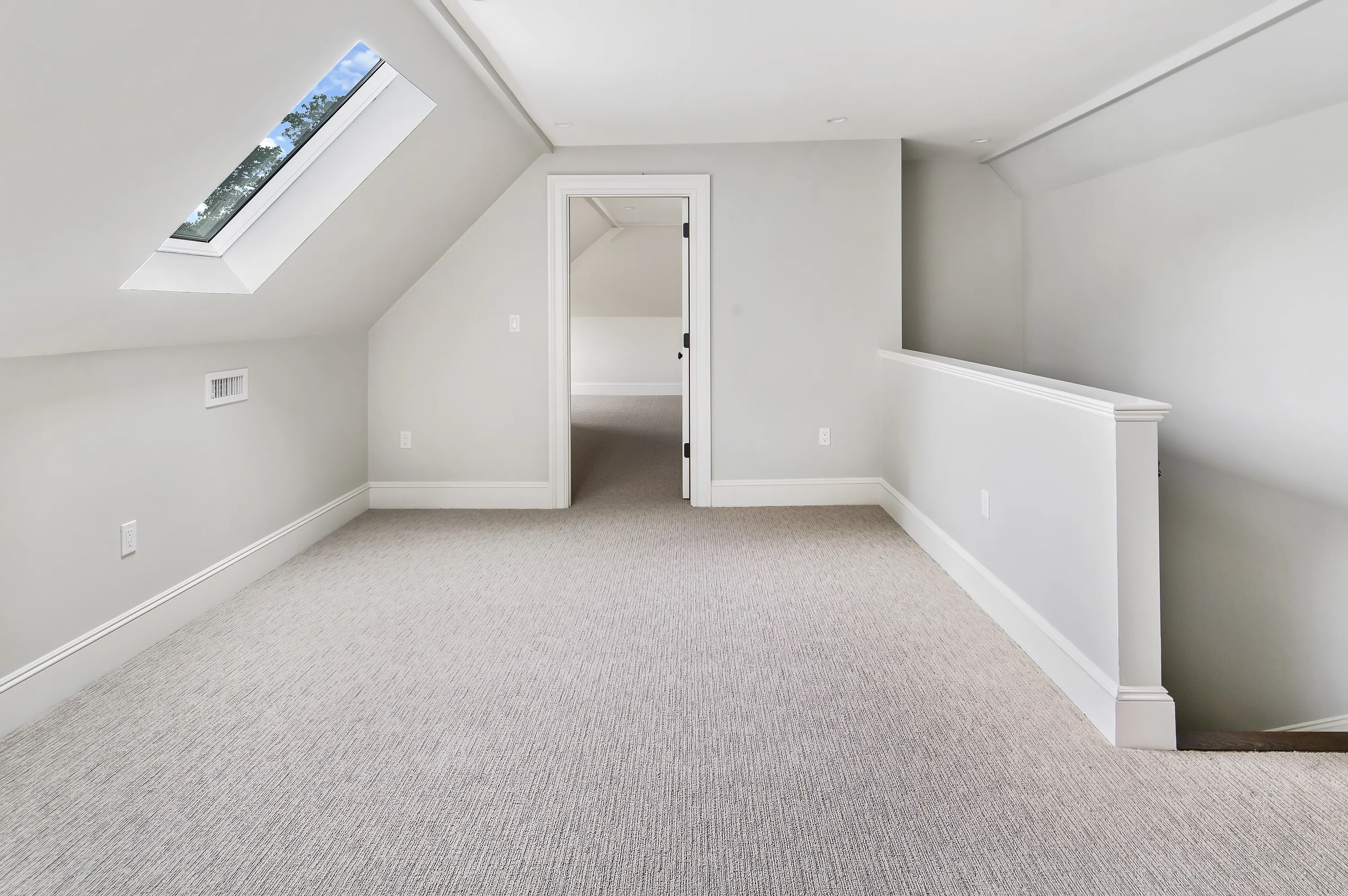 Finished third-floor space with a skylight in a Newton Tudor, an Abrams Builders project
